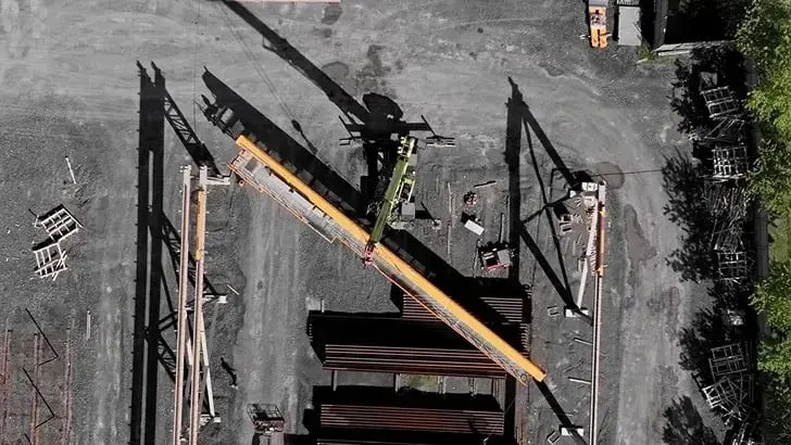 grue mobile soulevant un pont roulant pour l'installation