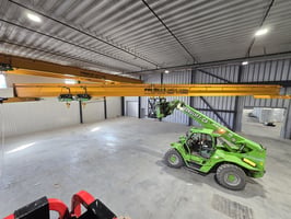 a lift lifting an overhead crane during installation