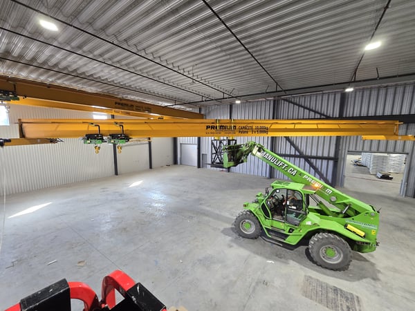 a lift lifting an overhead crane during installation