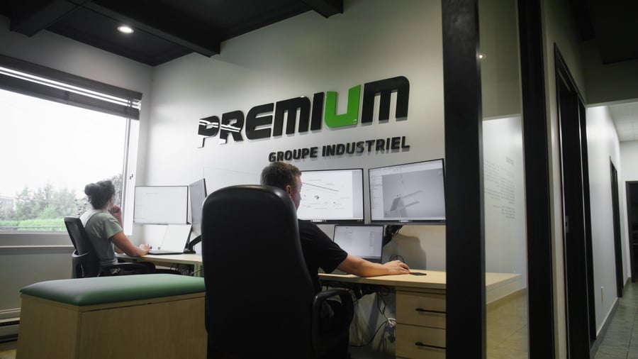 2 personnes devant leur ordinateur analysant des plans de fabrication de pont roulant