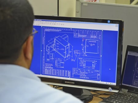 personne devant écran d'ordinateur affichant un plan de conception de pont roulant